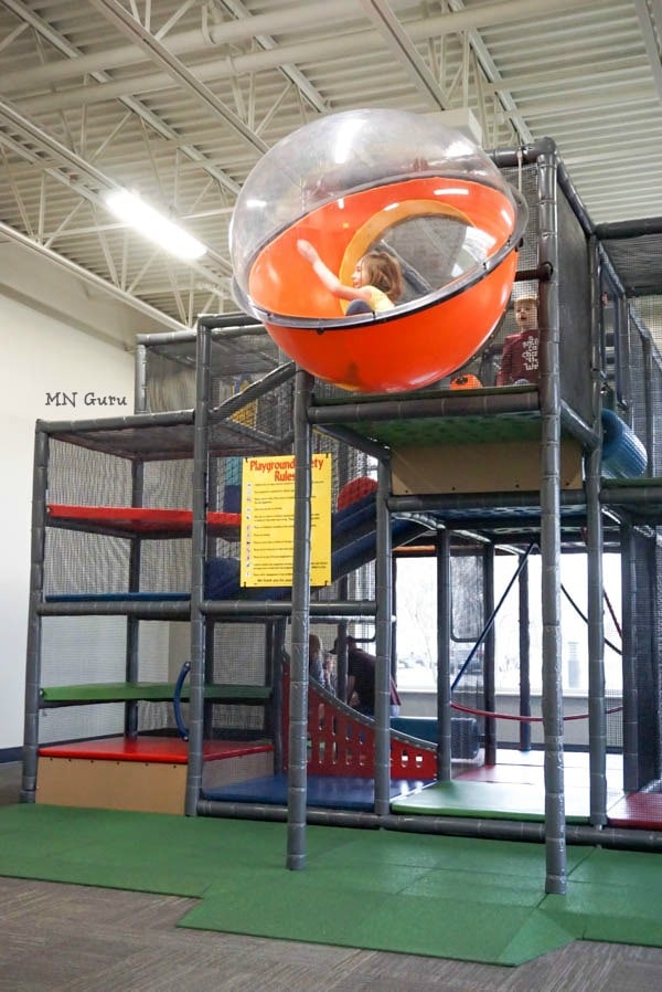Children using the upper level of the KidZone climbing structure in Sartell.