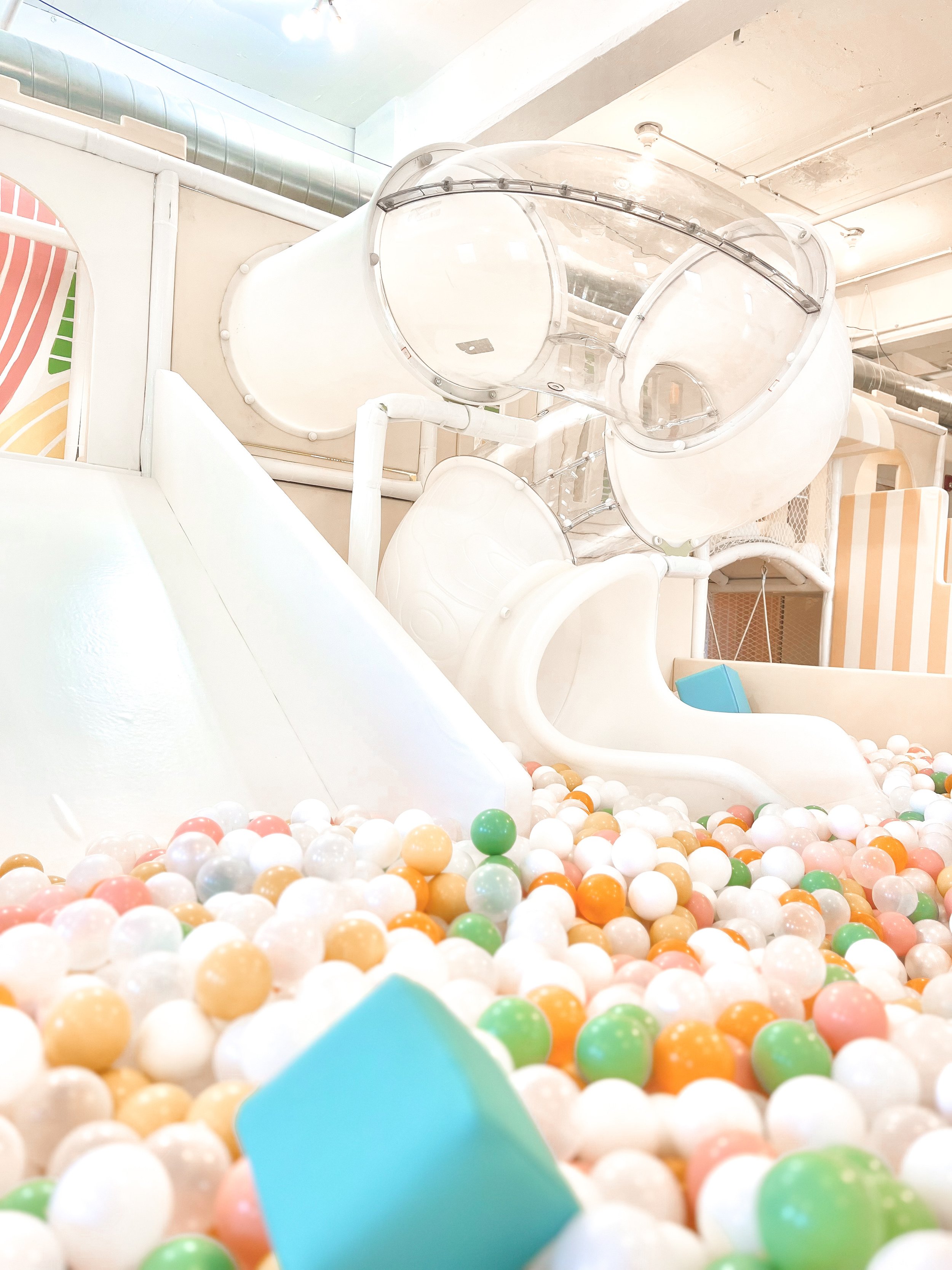 Tube slide emptying into a ball pit at Savy Playhouse