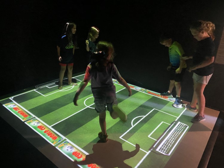 Children using the Beam Interactive projection floor at the Science & Discovery Center of Northwest Florida.