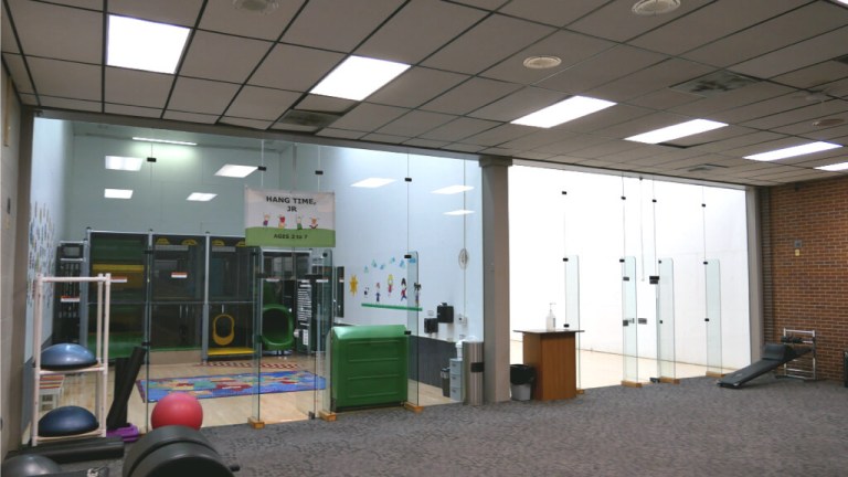 Overview of the Hangtime Jr play area behind glass inside the YMCA