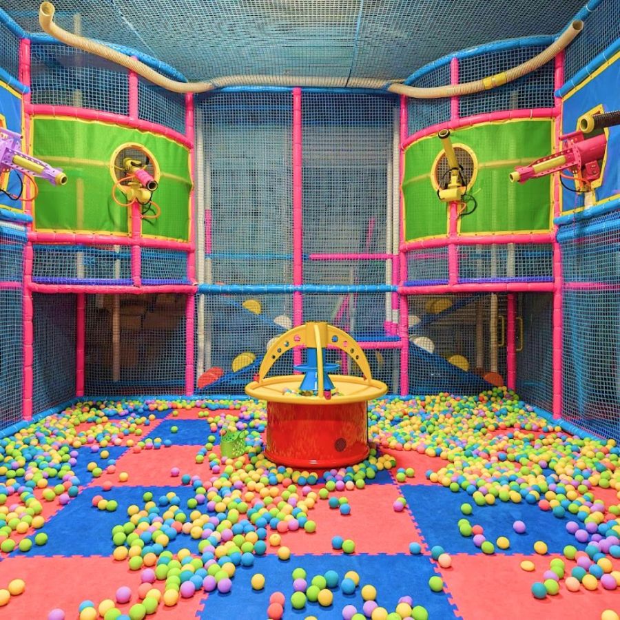 Colorful indoor play arena with foam ball launchers at Seascape Kids Fun.