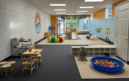Open play room with a ball pit, dramatic play setup, and flexible floor space at Seaside Play Cape Cod.