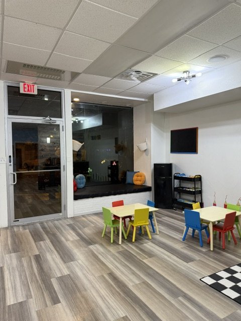 Child-sized tables and open floor space at Sensory Open Play Group.