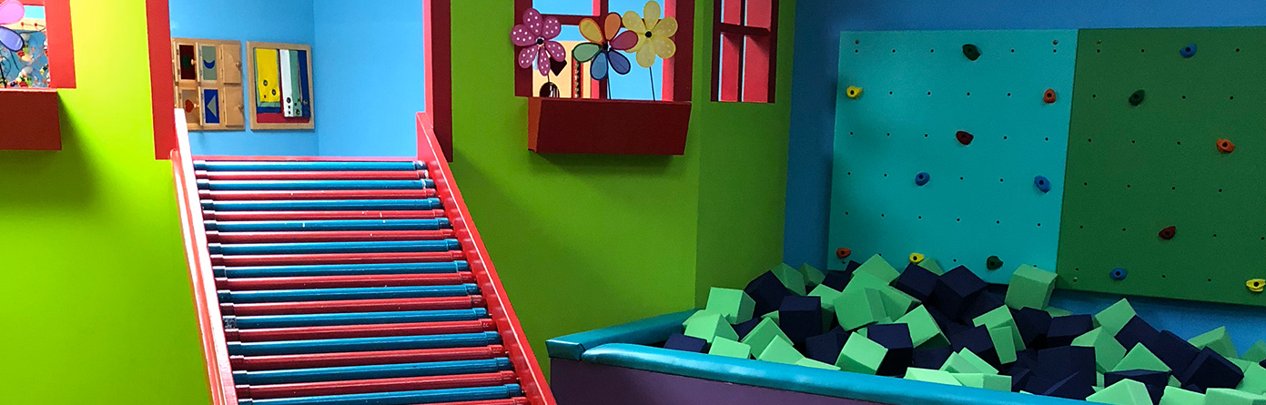 Interior of the Sensory Towne sensory gym with colorful movement and play equipment.