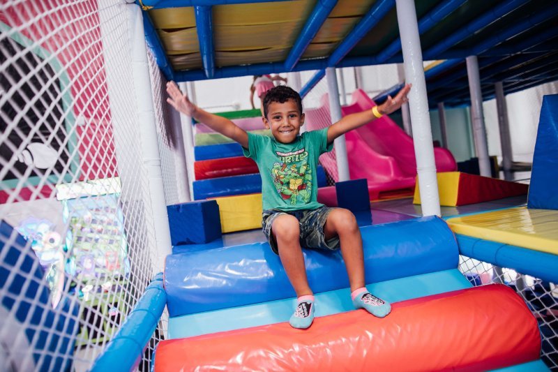 Child playing inside the enclosed Kid Zone at Shell We Bounce