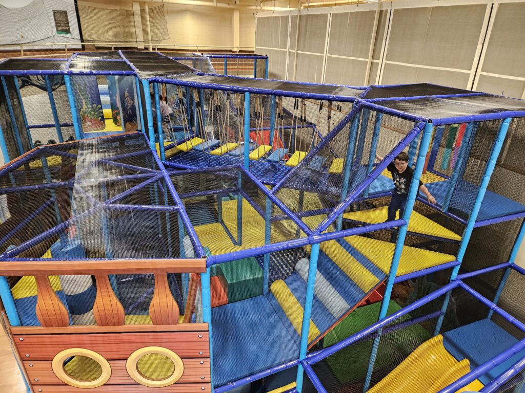 Large netted climbing structure inside Sheridan County YMCA Playland
