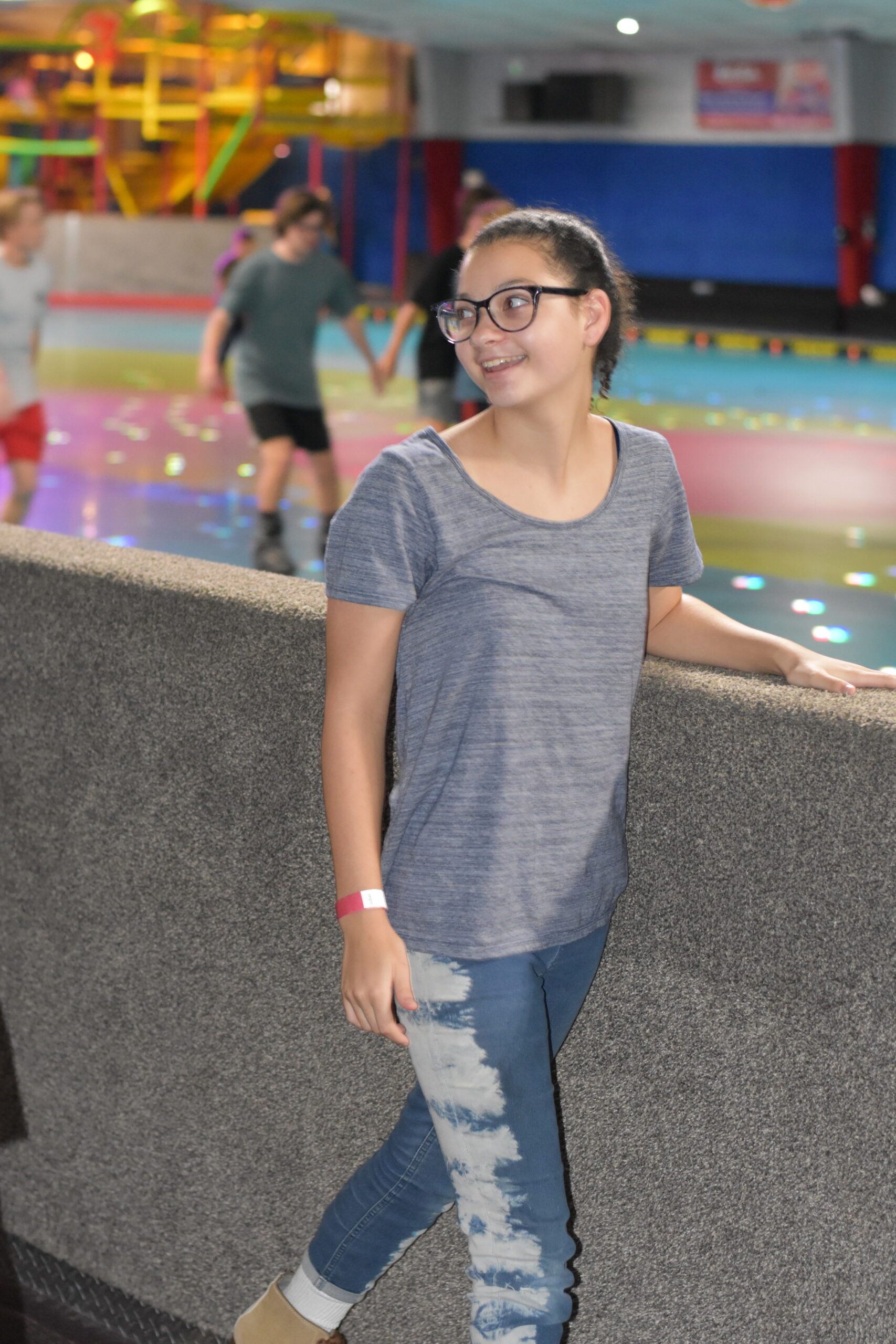 Skaters on the rink with the play area visible in the background at Skate World Center