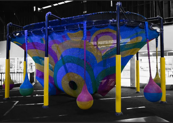 Kids climbing inside the Web Crawler area at Slick City