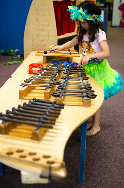Child exploring a hands-on imaginative-play station at Spark! in Morgantown.