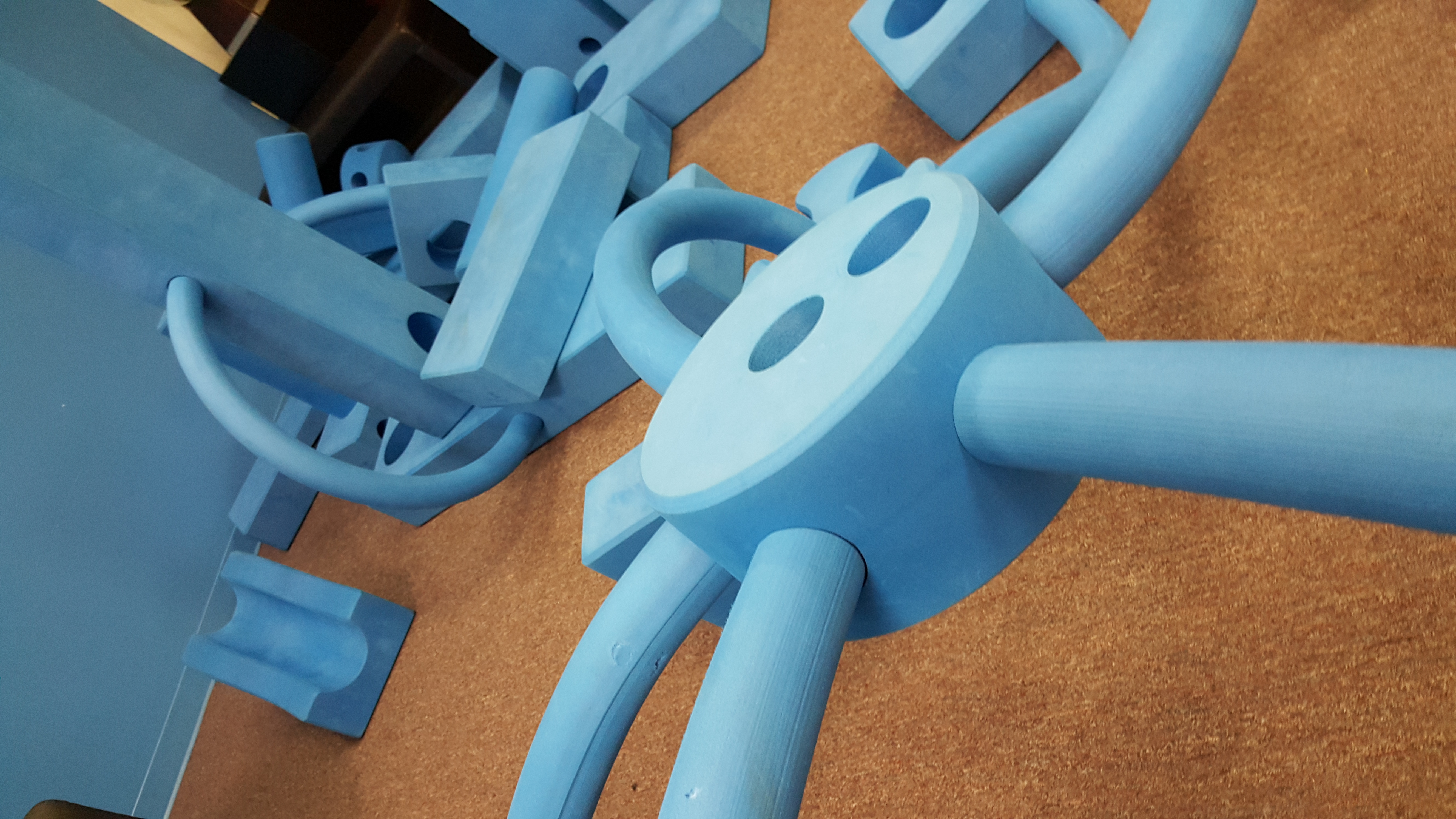Children building with oversized blue foam blocks at Spark! Imagination and Science Center.