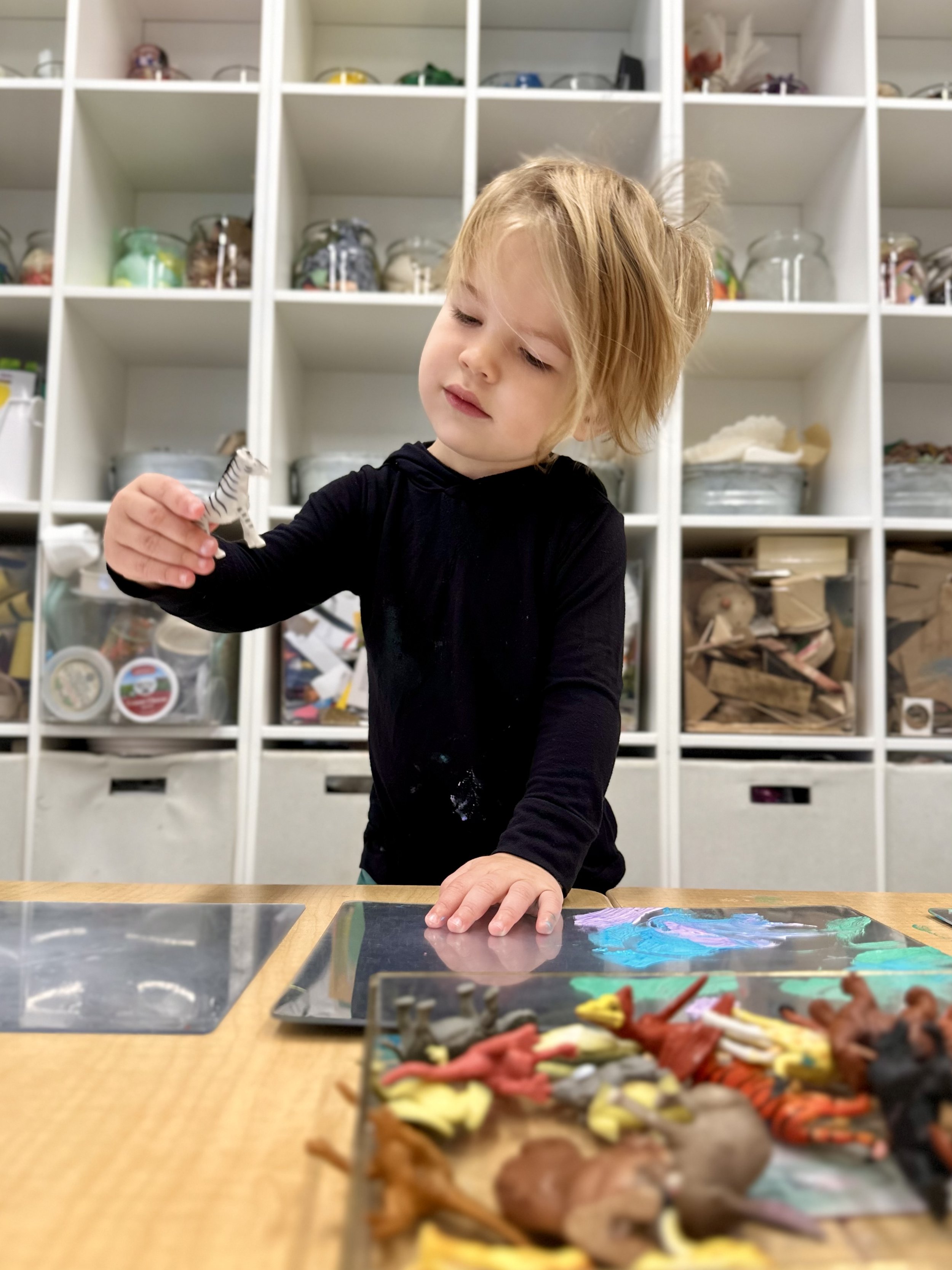 Child using art materials in the art studio at State of Play