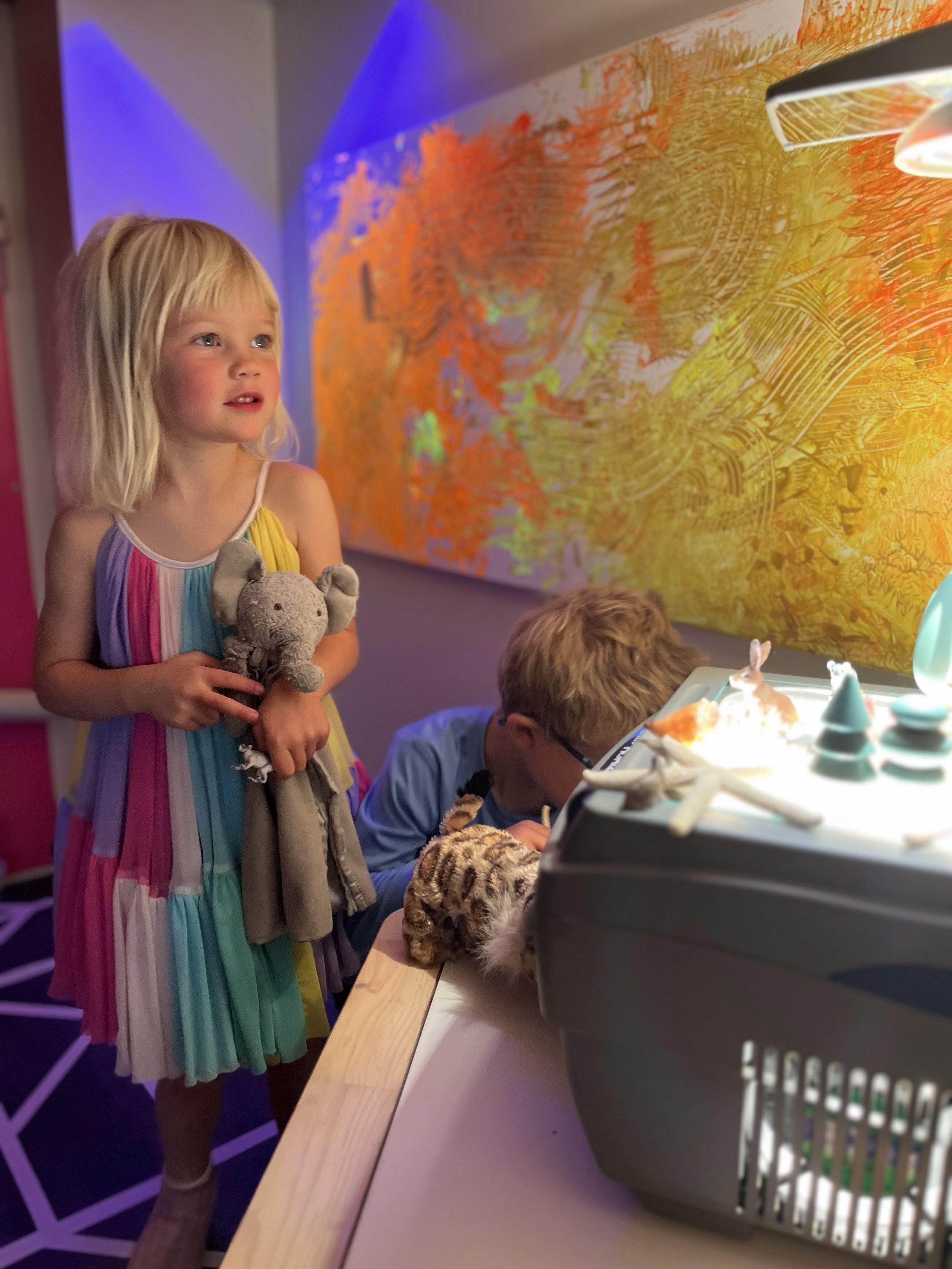 Children exploring the glow cave sensory area at State of Play