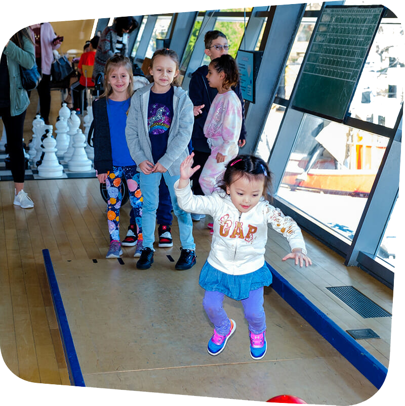 Children playing in the Big Games exhibit at Staten Island Children's Museum