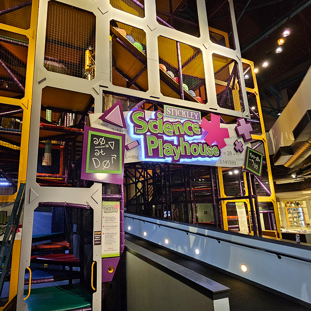Children using the Stickley Science Playhouse climbing structure
