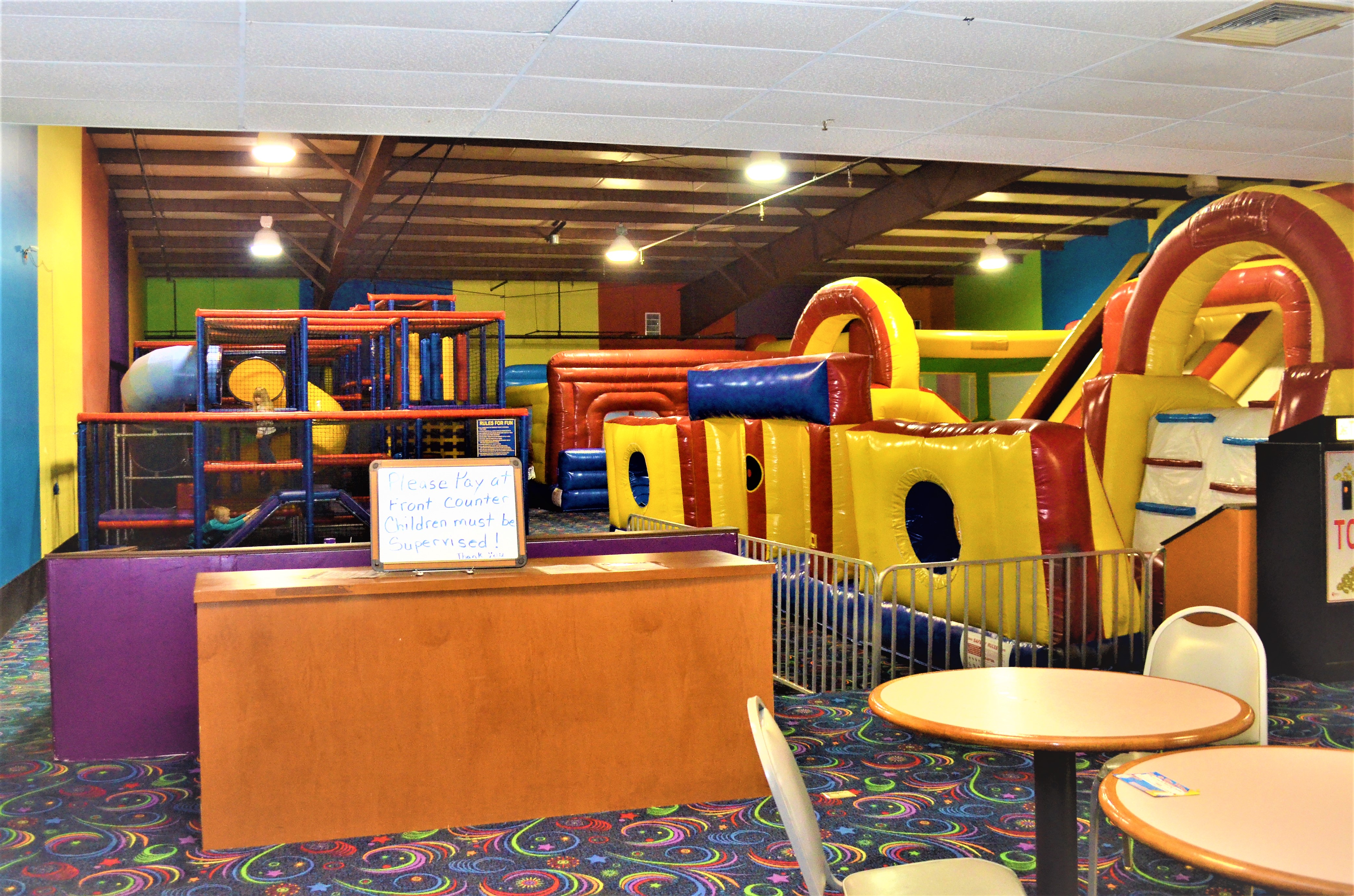 Children playing in the climbing and arcade area at Strikerz Party & Play.
