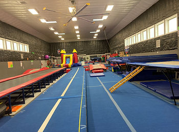 Open gym setup with tumbling equipment at TDC Athletics.