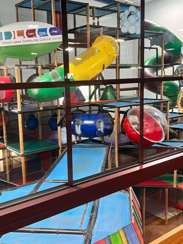 Colorful tubes and upper levels inside The Backyard indoor playground