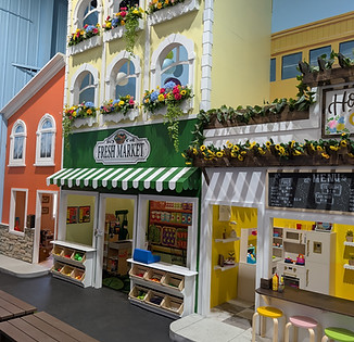 Pretend-play mini town area at The Bee's Knees Play Cafe.