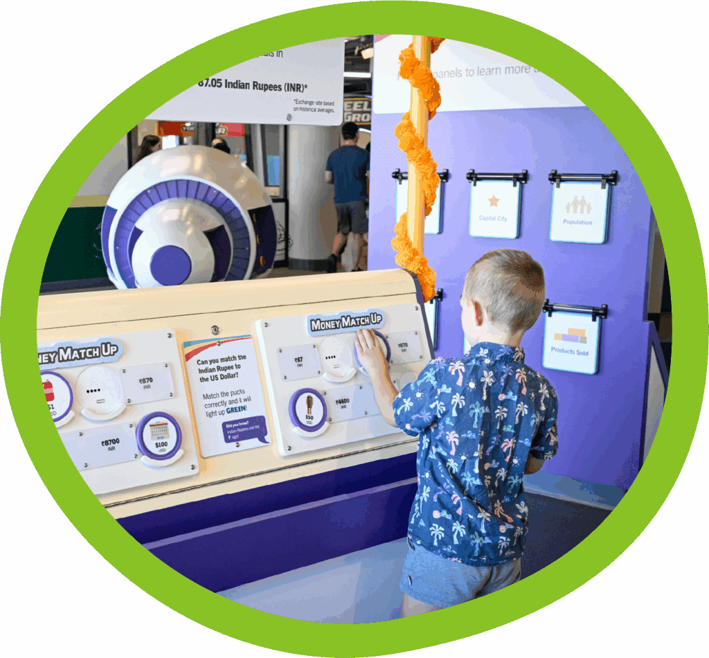 Child interacting with a colorful exhibit at TCMU Greenville
