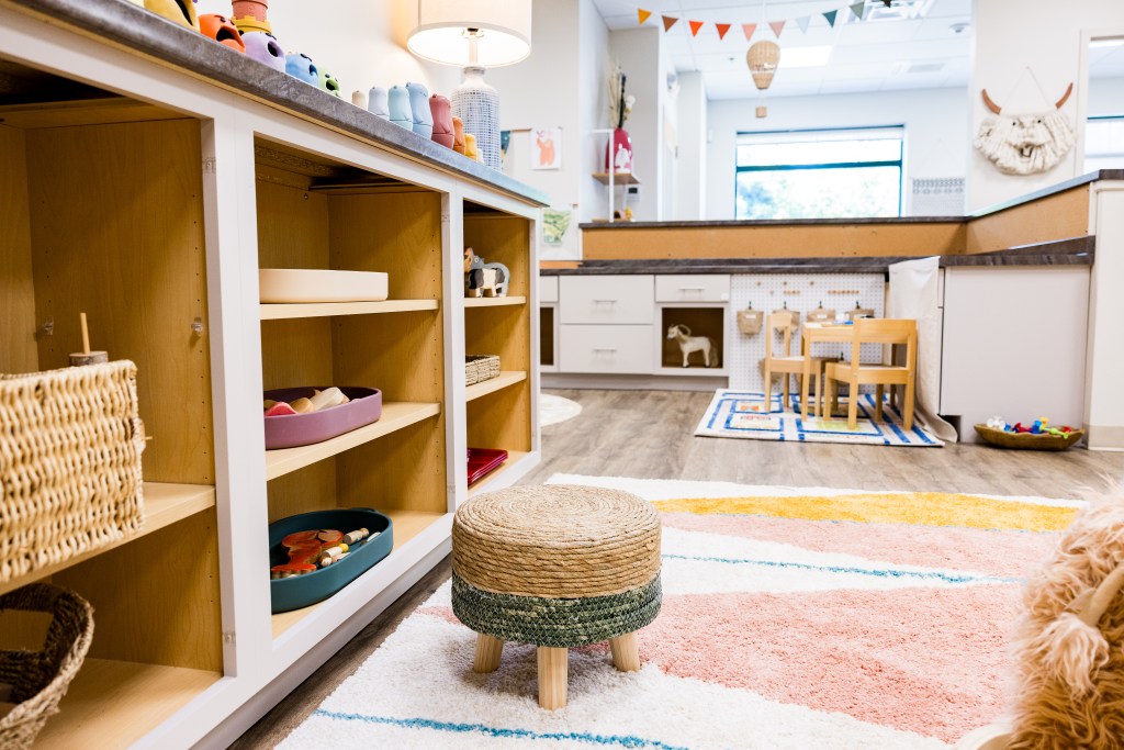 Pretend-play kitchen and child-sized play setup inside The Clubhouse.