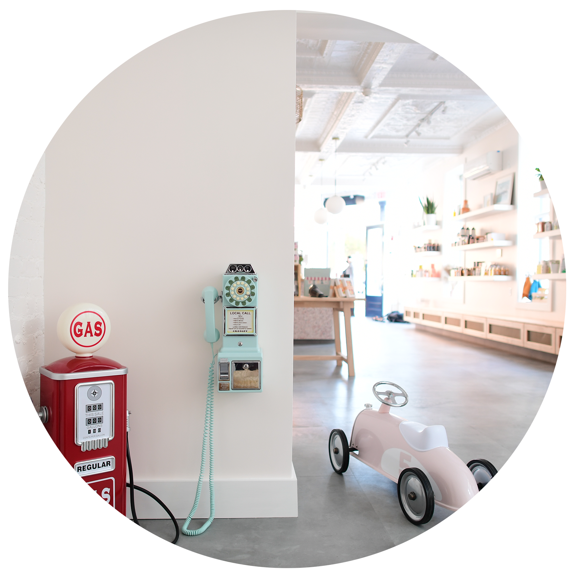 Ride-on toy and market-style corner inside The Hive's bright play-and-café space.