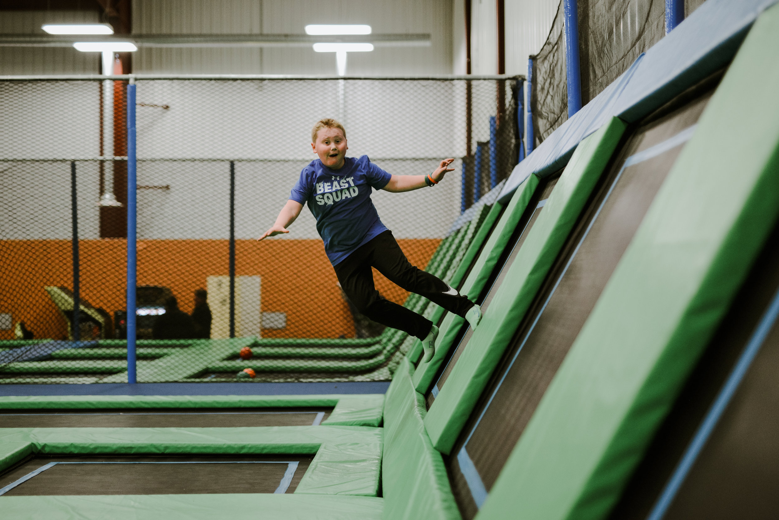 Child using the trampoline wall area at The Jump Station
