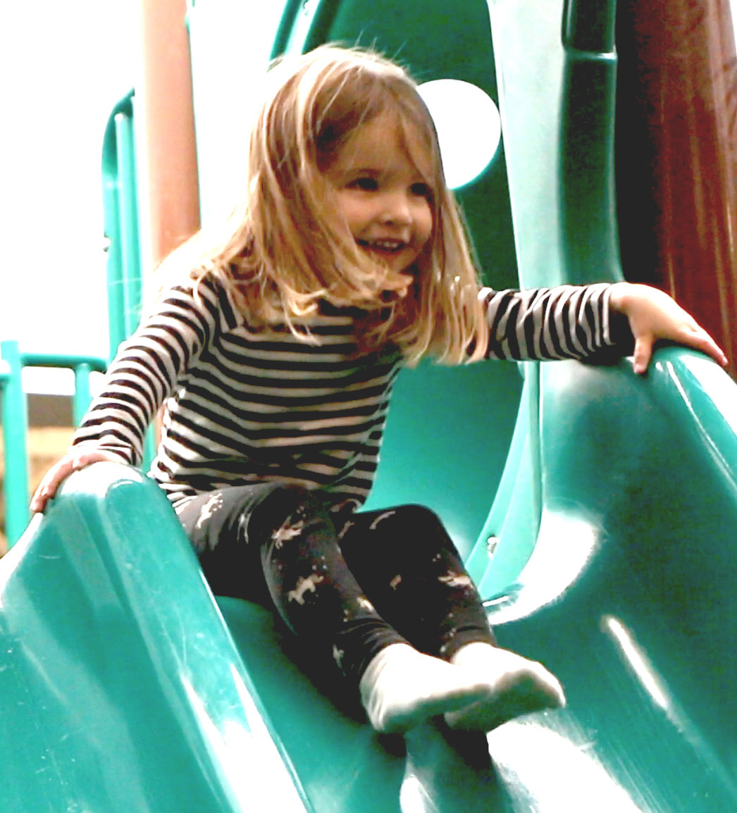 A child using the indoor slide at The Jungle playground.