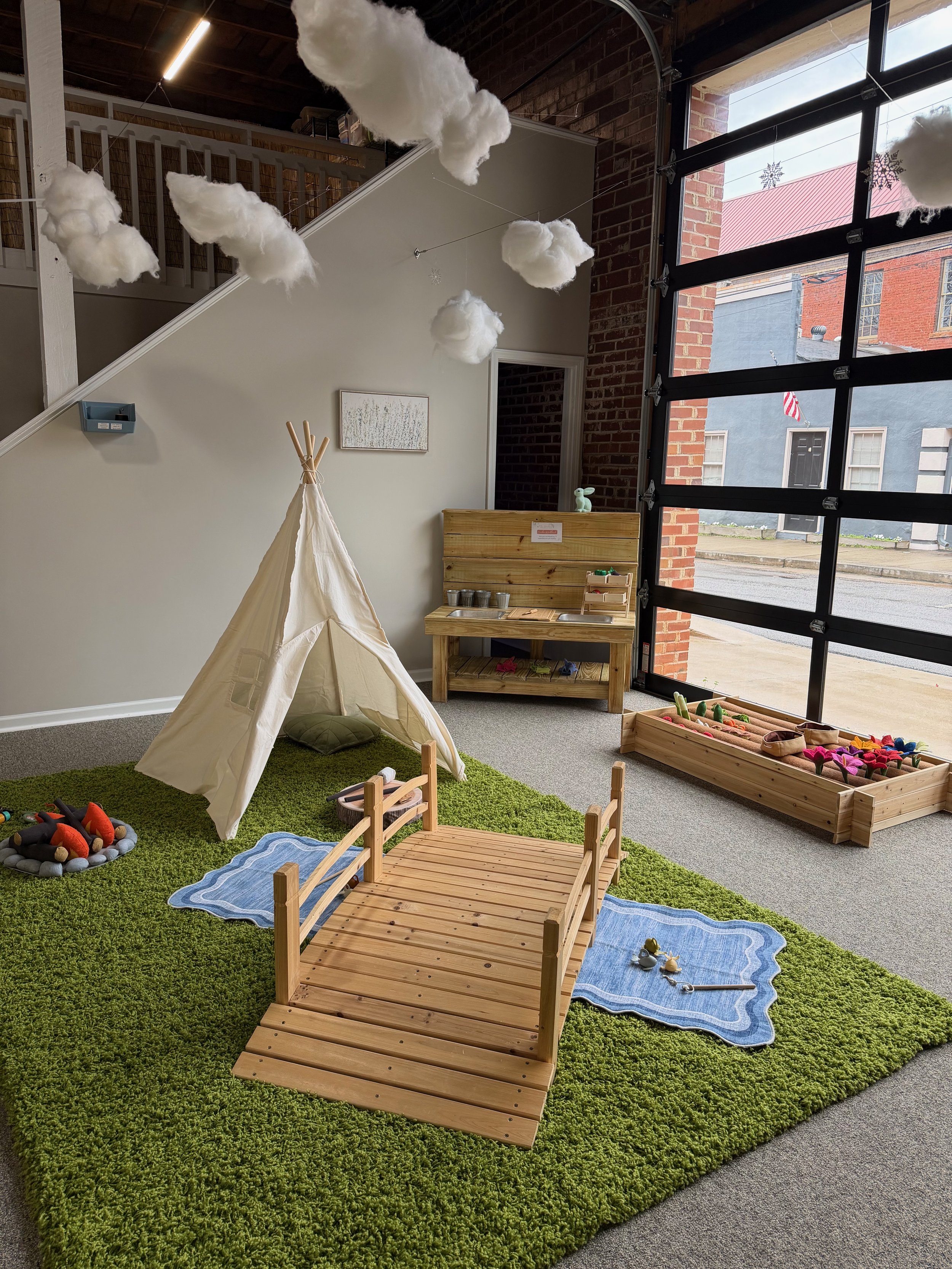 Calm play corner with bridge and nature-inspired setup at The Meadow Montessori Play Studio