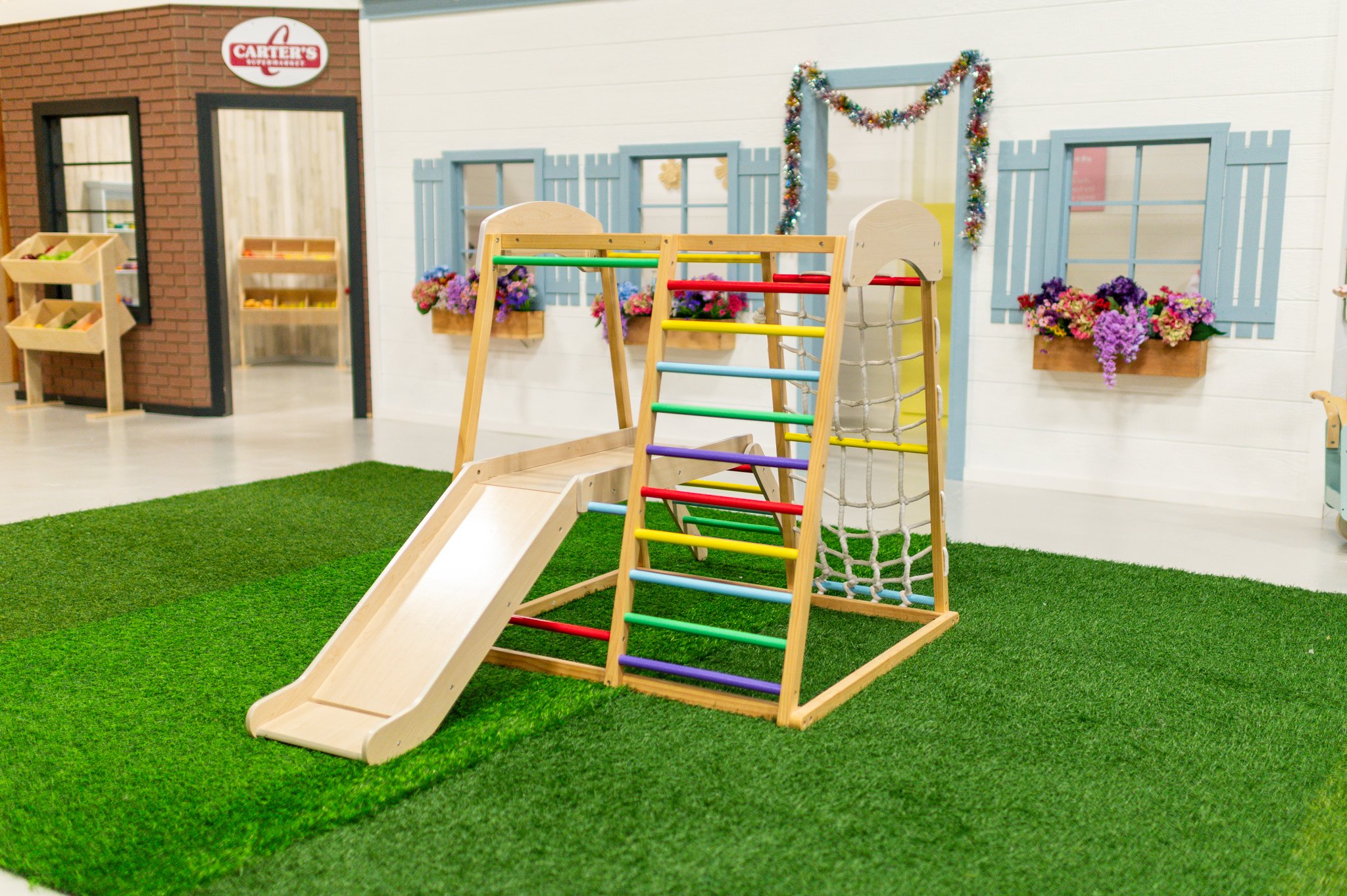 Indoor climbing and slide structure at The Play District.