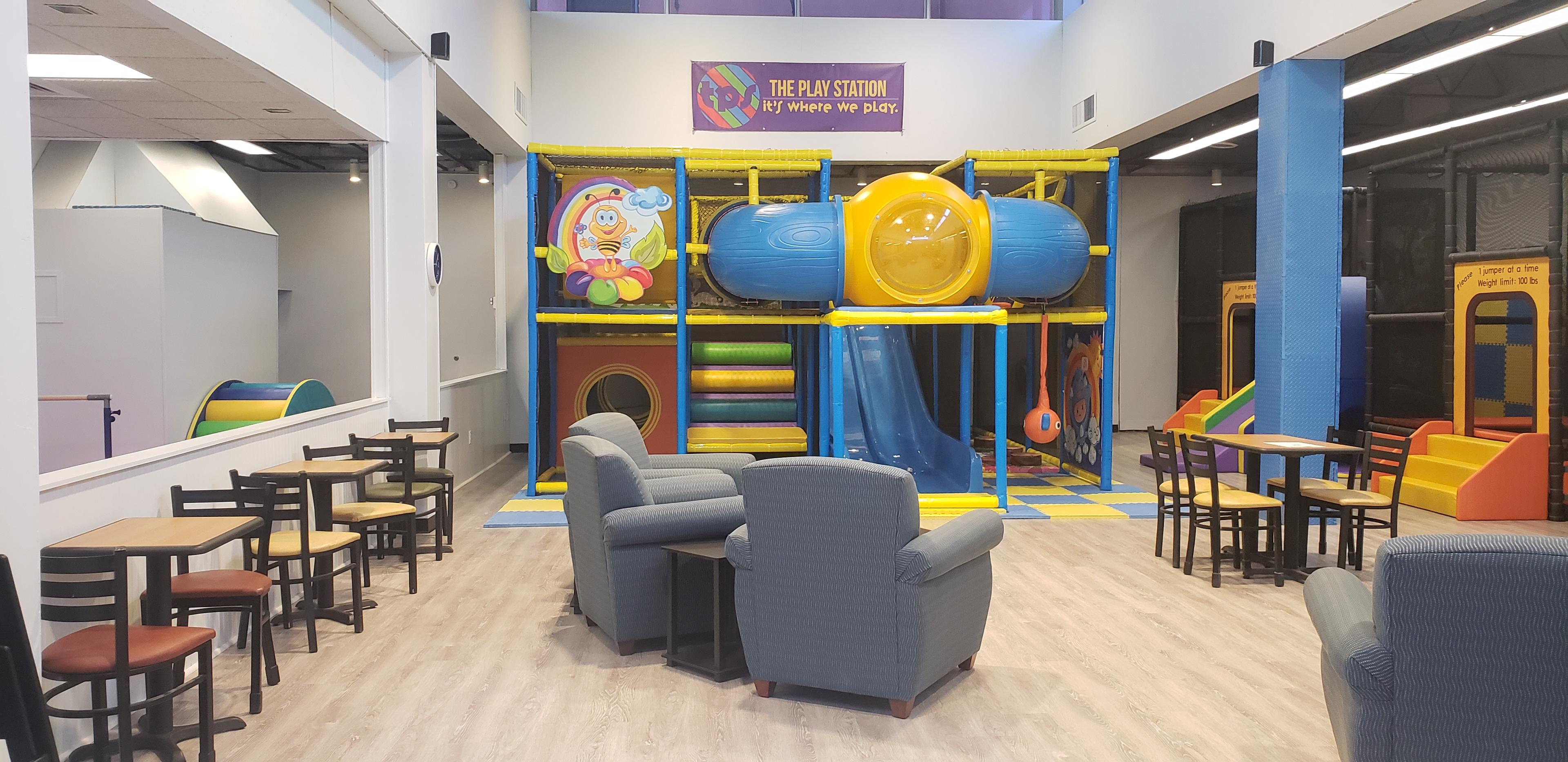 Main play structure and seating area at The Play Station in Milan.