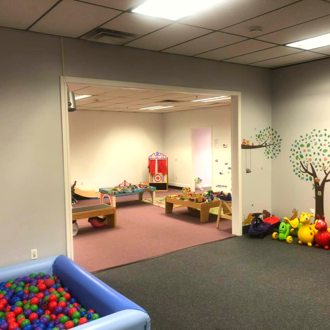 Ball pit and ride-on toy area inside The Rumpus Room.