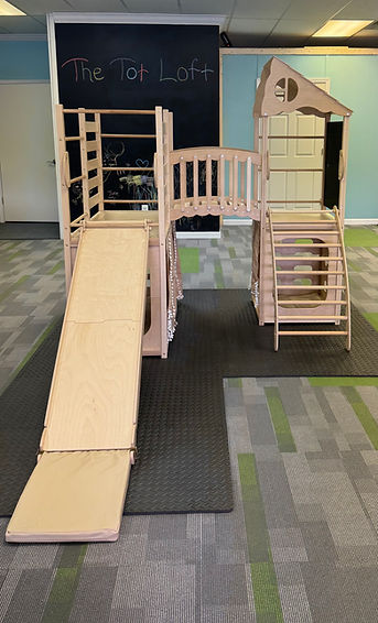 Wooden climbing and play structure at The Tot Loft