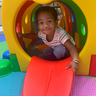 Child inside a tunnel feature at The Tot Spot Fun Factory.