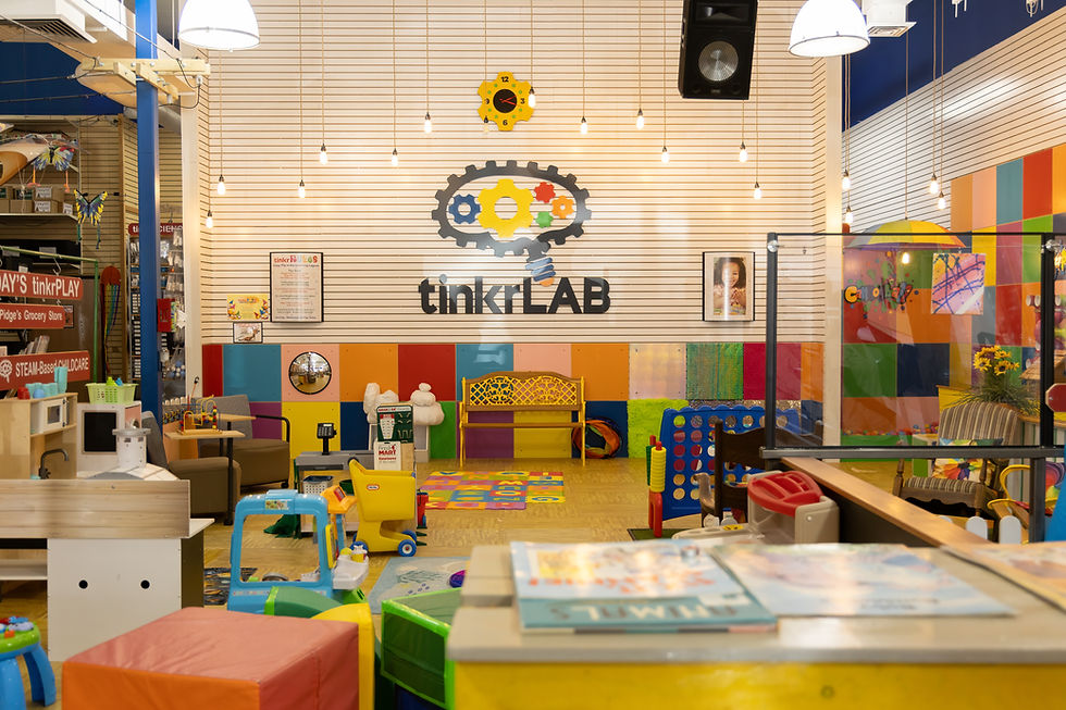 Wide view of tinkrLAB's colorful indoor play and learning space.