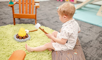 Child using the pretend-play area at Tiny Beans Play Cafe