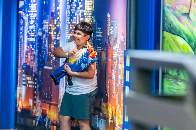 Player inside the foam dart arena at Top Shot Maui