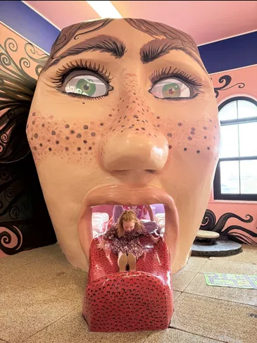 Child coming down the slide built into the museum's giant human-body exhibit.