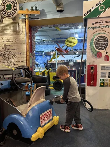 Child playing inside the kid-sized city exhibit at the museum.