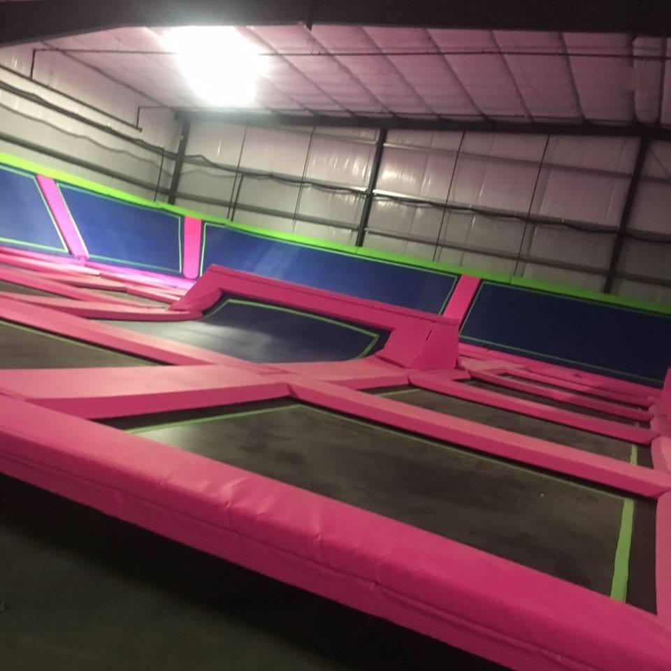 Large connected trampoline courts at UpSurge Trampoline Park.