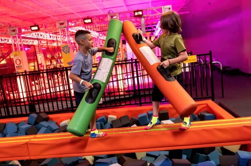 Kids balancing over a foam pit attraction at Urban Air Augusta.