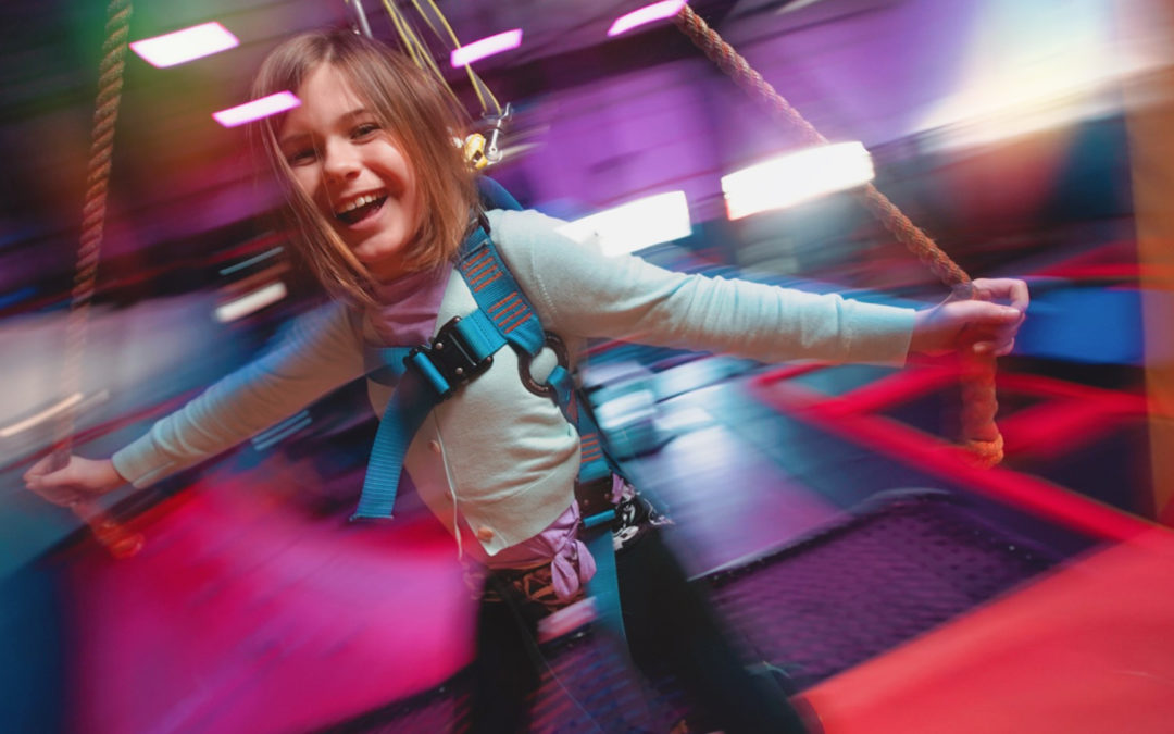 Child riding the Sky Rider attraction at Urban Air west El Paso.