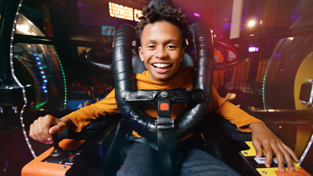 Child smiling in a bumper car attraction at Urban Air Evansville.