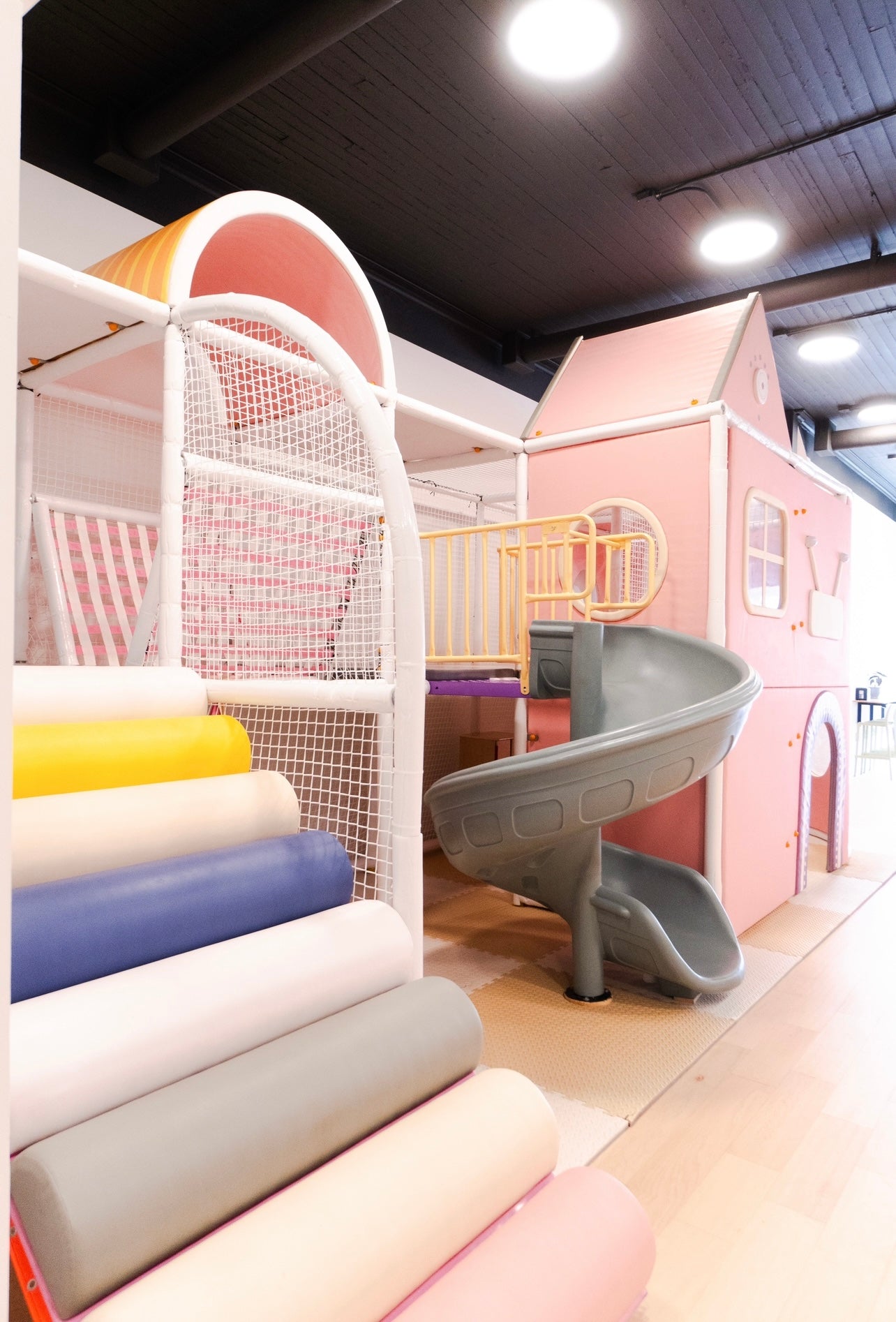 Playhouse, slide, and kid-sized play area inside Urban Brew.