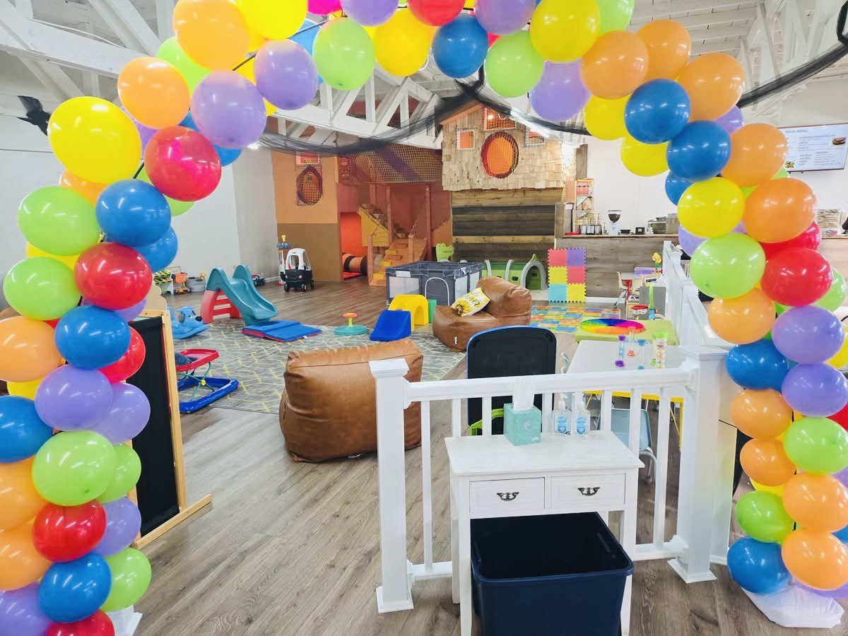 Open play area with seating inside Village Play Cafe