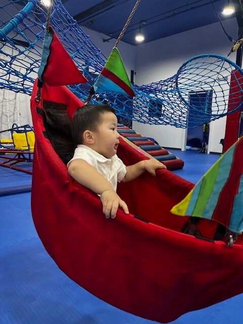 Suspended sensory play equipment inside We Rock the Spectrum - Bergen.