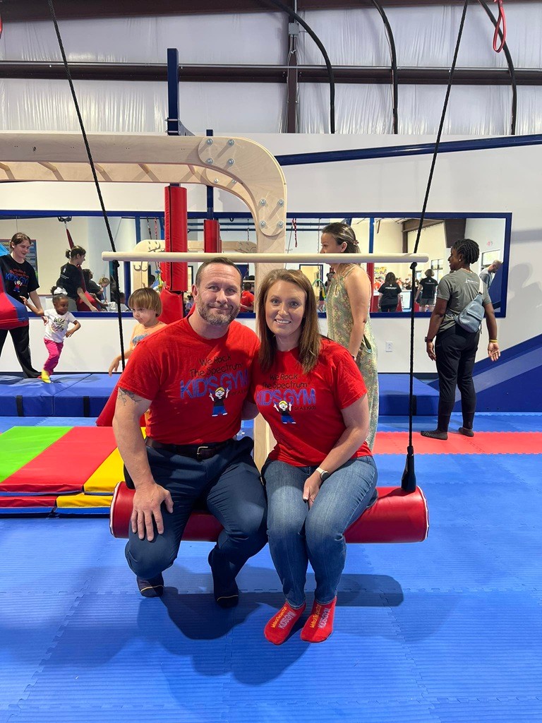 View inside We Rock the Spectrum Summerville showing swings, mats, and open sensory-gym space.