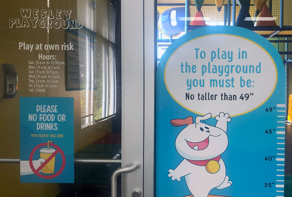 Wesley Playground entry signage with height limit and hours