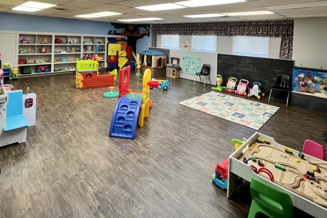 Wide view of the Wiggles & Giggles playroom with toddler-scale toys and activity areas.