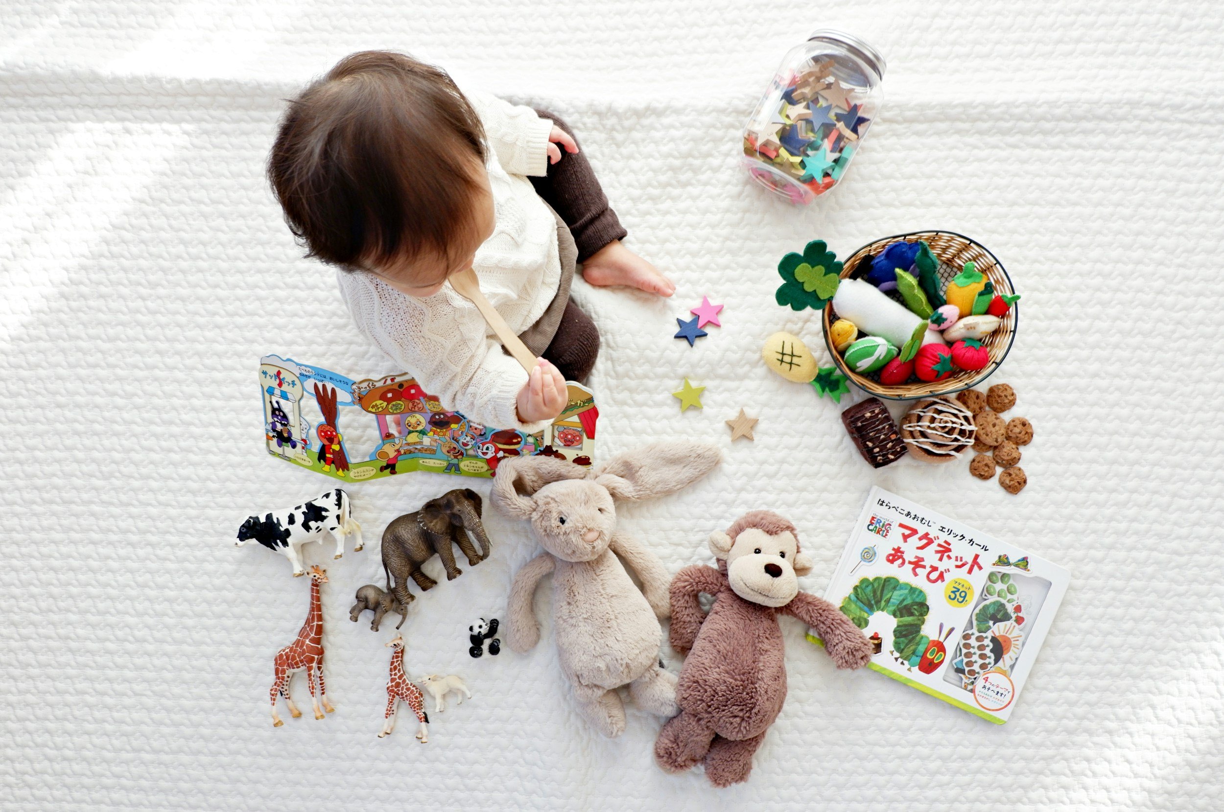 Infant play setup with toys and books at Wild+Wander Play Studio.