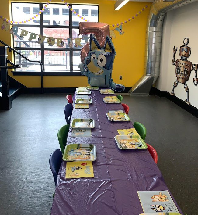 Birthday party table setup inside Wonderfeet Kids' Museum.